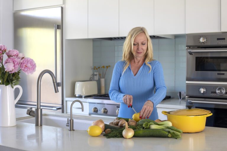 The alt text is not a file name so you write it as a normal sentence. A middle-aged woman chopping vegetables in her kitchen, highlighting healthy meal preparation for weight loss